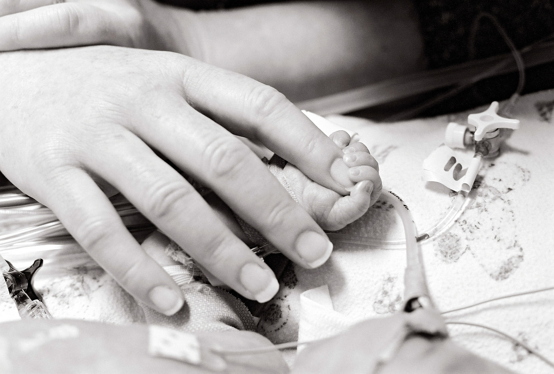 baby holding mom finger